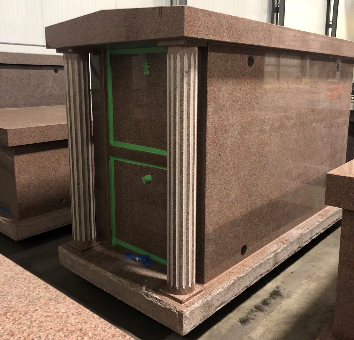 This in-stock and pre-assembled mausoleum is for sale for $34,087.00 at Rome Monument. It is built with rose colored granite, a gable style roof and round fluted columns. 02-23-2023