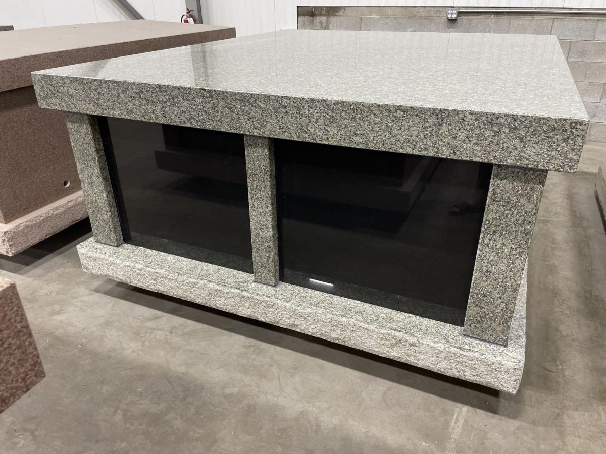 Pictured here is an in-stock pre-assembled 2 crypt olive grey granite mausoleum with a black granite front for sale at Rome Monument for $26,878, 02-21-2023