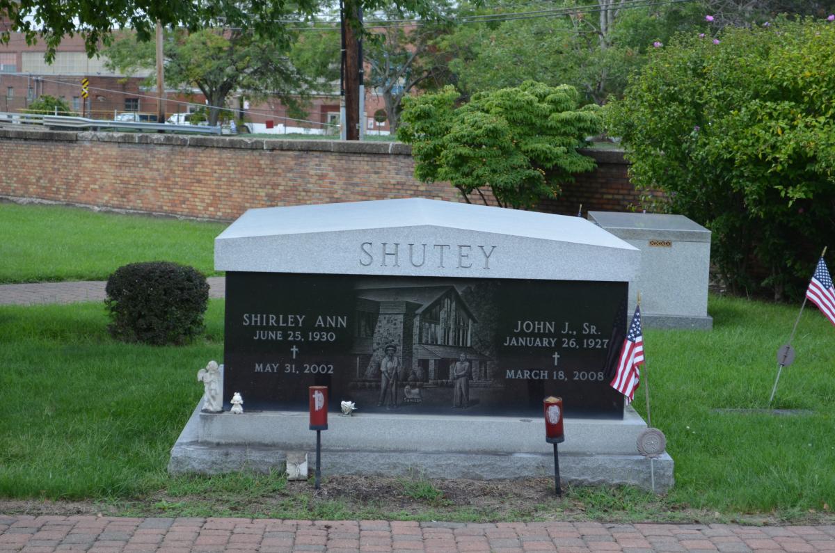 Pictured here is a double crypt mausoleum built to hold 2 people which is a solid granite container that features a laser etched scene, names, birth and death dates.