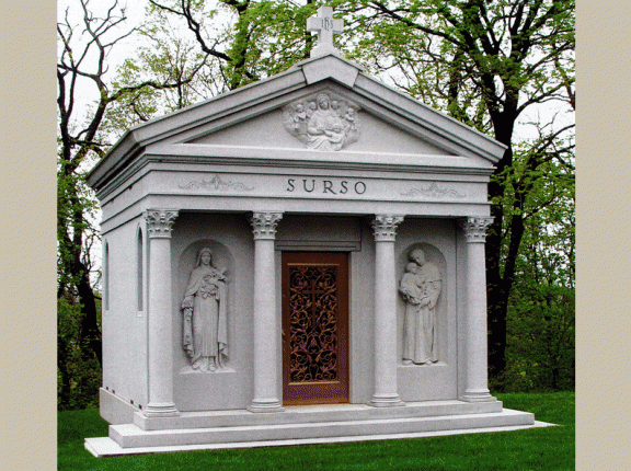 Pictured here is an eight crypt private family mausoleum custom designed with Corinthian columns and three sculptures.