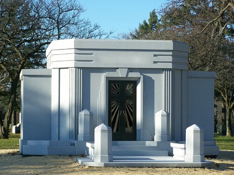 The beautiful private walk-in Flynn Mausoleum was designed in a sleek Art Deco architectural style with 2 carved guardian angels similar to the winged figures at the Hoover Dam