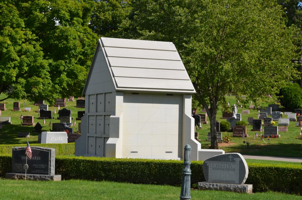 The custom designed 9 crypt chapel style private family mausoleum pictured here was constructed by Rome Monument craftsman and was built with Rock of Ages granite